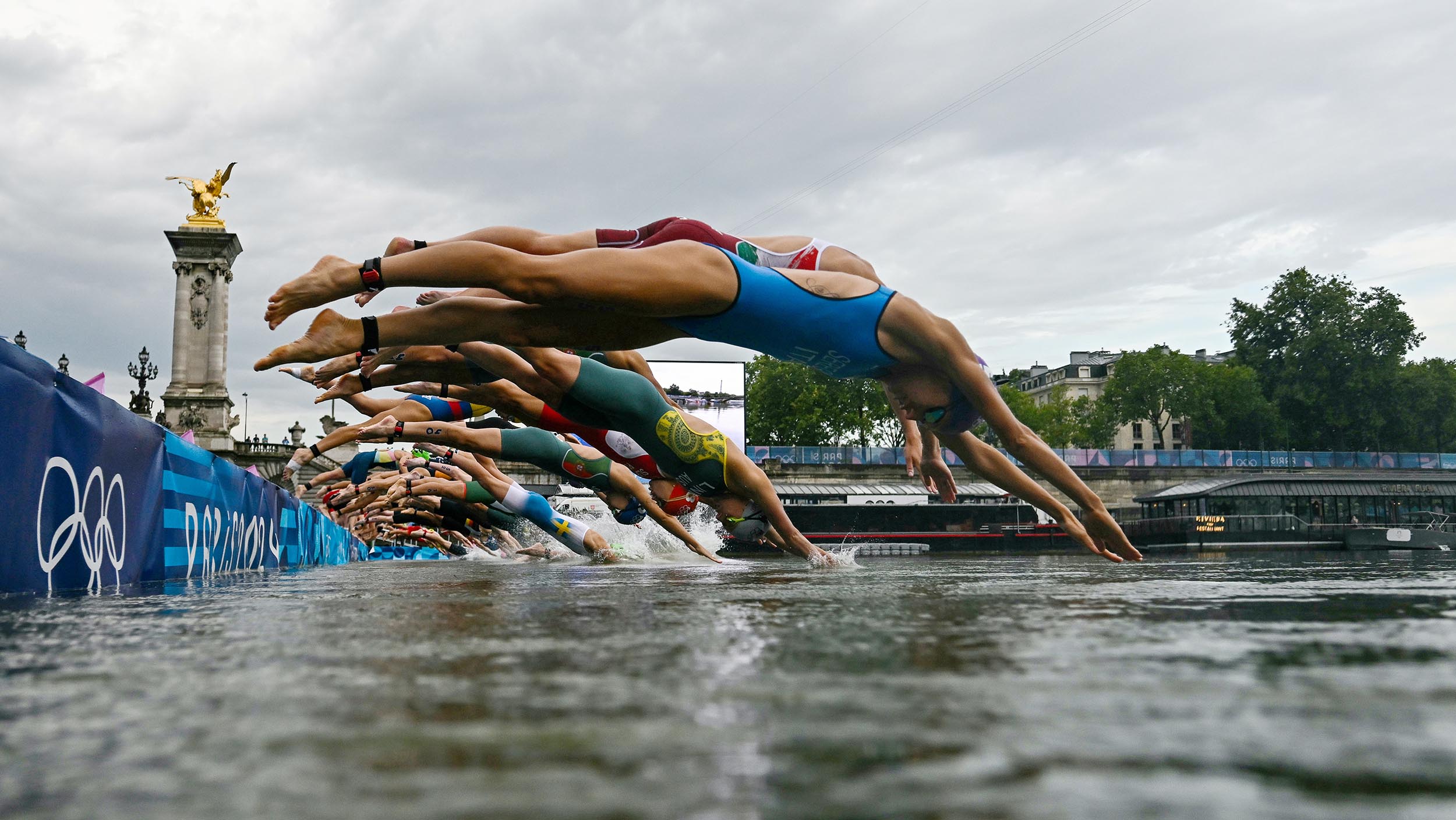 Amid concerns about dirty water and strong current, marathon swimmers dive into the Seine River